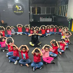 An instructor joins the students in the center of their heart formation, showing the close bond we share. We are proud to be a part of their dance journey.