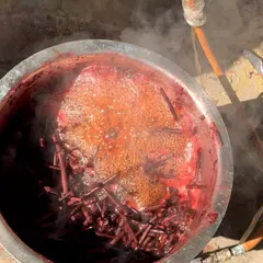 A pot of natural dye, derived from madder root, bubbles away. This is the beginning of creating the rich, earthy red tones you see in many of our textiles. The process is slow, but the results are worth it.
