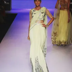 A moment from the runway featuring a lime yellow georgette saree. The design is elevated with delicate butterfly motifs and Swarovski crystal detailing, blending modern style with classic elegance for a high-fashion statement.