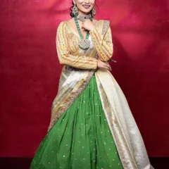 A full view of the green and silver-look jewellery paired with a half-saree. This is a wonderful option for an engagement or pre-wedding celebration.