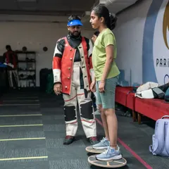 Balance and core strength are crucial for a shooter's stability. Here, I am guiding a young athlete through a balance board exercise to improve her stability and posture.