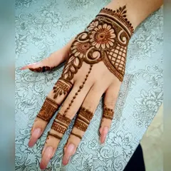 A chic and modern design featuring a floral vine connected to the fingers with a delicate chain of dots. This is a popular choice for parties and engagements.