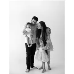 A quiet, tender moment shared between a family of four. The gentle interactions and loving gazes are what make a family portrait truly special. I focus on capturing these real connections.
