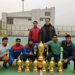 The victorious university team, including our players Udit Kamboj and Ricky Chaudhary, posing with their impressive collection of trophies from the North Zone tournament.