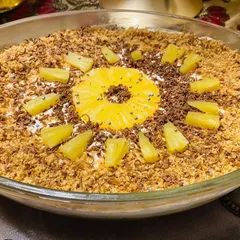 This is my super refreshing and extremely delicious Pineapple Delight. It's a creamy, no-bake dessert topped with crushed biscuits, chocolate shavings, and fresh pineapple.