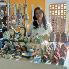 My full stall display at the Hyderabad Potter's Market, featuring my Pop Art sculptures alongside my whimsical house lanterns and other creations. The bright colors really stand out.