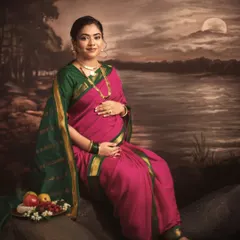 This portrait captures a serene moment by the water, inspired by the mood and lighting of a classic painting. The composition, with the fruit platter and moonlit backdrop, adds layers of symbolism to this fine art maternity photo.