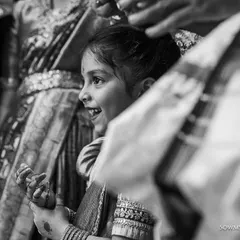 A black and white shot of a young girl watching the wedding ceremony with wide-eyed wonder. We love capturing the reactions of guests, both young and old.