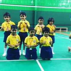 All smiles on the court. These young champions are ready for their lesson, showing the fun and excitement that is a core part of our coaching philosophy for children.