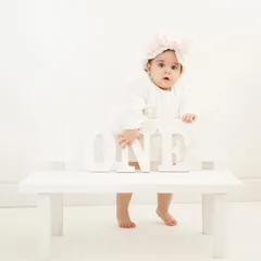 A classic and clean all-white setup for a first birthday shoot. This minimalist approach puts all the focus on your little one's adorable expressions as they celebrate turning one.