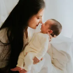 A gentle nose-to-nose moment between a mother and her newborn. This close-up shot is incredibly intimate and full of unspoken love.