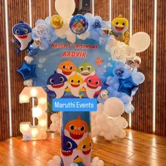 An underwater adventure with a Baby Shark theme for Aadvik's 3rd birthday. The setup includes a character backdrop, blue and white balloon clouds, and a light-up number '3'.