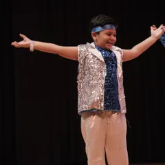 The joy on their faces says it all. A young performer from our 'Dancing Rockets' group, having the time of his life on stage.