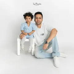 Capturing the special bond between a father and his daughter. This simple, seated pose allows for a quiet moment of connection, resulting in a timeless dad and daughter portrait.