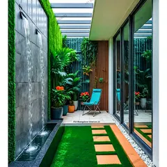 Even a narrow space can accommodate a calming water element. Here, a sleek, modern waterfall flows down a textured wall into a small channel, surrounded by a lush vertical garden and artificial grass.