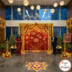 A beautiful backdrop sets the stage for any event. For this corporate Diwali party, I designed a stunning red and gold fabric backdrop with lotus motifs, framed by marigold garlands and traditional brass lamps, creating an elegant and traditional photo opportunity.