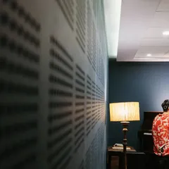 Jacob at the piano during our session. The wall behind him lists names, but that night, the only language in the room was music.