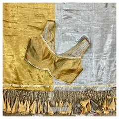 A gold and silver tissue saree with dramatic tassels, which we paired with a chic sleeveless, ruched blouse with metal sequin accents.