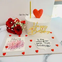 A sweet and simple birthday cake platter. This one includes a personalized message, a calendar marking the date, and a small bouquet of fresh red roses to complete the celebration.