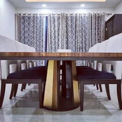 The formal dining room in Villa 9/21B, featuring a custom-made table with a striking metallic base and upholstered chairs. This space was designed for sophisticated entertaining, with careful attention to material and form.