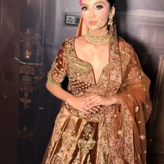 A full view of this stunning bridal look from our shoot. The deep V-neck blouse and rich brown velvet lehenga are perfectly complemented by the radiant, glowing makeup.