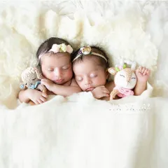 Two sleeping beauties. For this newborn twin portrait, I added delicate floral headbands and tiny stuffed animals to create a sweet, dreamy scene.