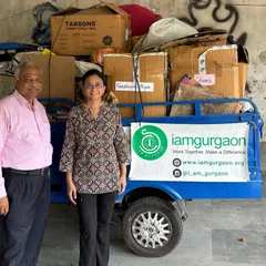 Two residents stand proudly next to our electric vehicle, loaded with waste collected from their community. Their proactive involvement is what drives our movement forward.