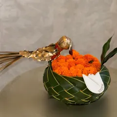 The Diwali season is here. This simple, elegant arrangement features a bowl of auspicious marigolds woven from palm leaves, accented with a golden bird. It's a beautiful reminder of gratitude, love, and respect for tradition.