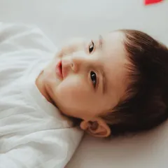 A close-up portrait of a happy five-month-old baby, capturing his sweet smile and bright eyes.