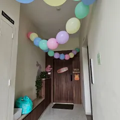 A simple yet festive way to welcome guests. A colorful pastel balloon garland leads the way to the front door of the party residence.