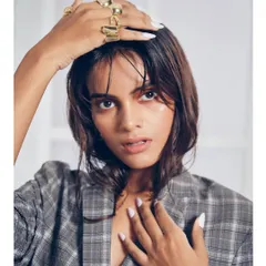 An edgy, contemporary look featuring a 'wet hair' style and a glossy, dewy skin finish. The subtle color wash on the eyes adds a touch of fashion-forward detail, perfect for a model's test shoot.