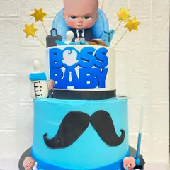 Our popular Boss Baby theme, perfect for a little one turning one. This two-tier butterscotch cake is all business, decorated with a pacifier, briefcase, and a moustache.