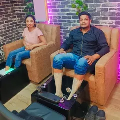 A couple enjoying a relaxing pedicure treatment side-by-side at our salon.