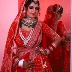 A close up of this stunning bridal makeup, showing the flawless base and expertly blended eyeshadow. The red lip and defined eyes create a powerful yet elegant look.