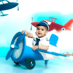 Ready for takeoff. This little pilot is in command of his own airplane, set against a bright blue sky. It's a perfect theme for an adventurous child.