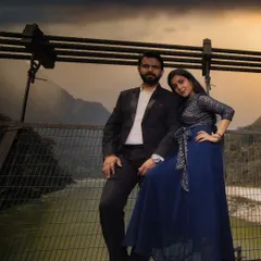 A dramatic pre-wedding portrait on a bridge in Rishikesh. The moody sky and the majestic mountains in the background add a sense of grandeur and adventure to their love story.