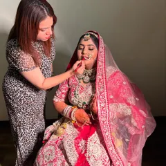 A behind-the-scenes shot of me working on the lovely bride, Dipika. Here, I am carefully applying her lipstick to create the perfect pout.
