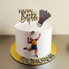 A clean and simple badminton themed cake, perfect for a player's birthday. It features a racket, shuttlecock, and a player in action.