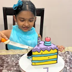 Our daughter's excitement says it all! Here she is, about to cut her very own comic slice cake.