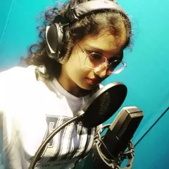 A candid shot from a studio session. This is me completely in the zone, focused on the details of the vocal track and making sure every note carries the right emotion for the song.