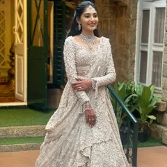 A full-length shot showcasing the stunning, intricately detailed gown. This look is all about modern elegance and making a grand statement.