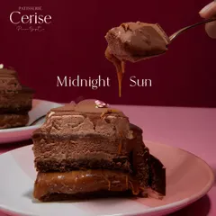 A close-up of the Midnight Sun, where you can see the gooey caramel layer beneath the rich chocolate mousse. This is a dessert for those who appreciate true decadence.