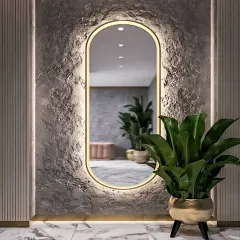 A stunning entryway detail featuring a textured accent wall with a backlit oval mirror. This design element adds a touch of drama and sophistication right at the entrance of the home.