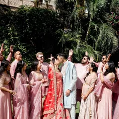 A joyous celebration with family and friends. The groom's bespoke sherwani stands out beautifully amidst the coordinated outfits of the wedding party.
