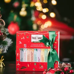 A Christmas-themed product shot featuring a festive chocolate gift box against a backdrop of twinkling lights. I use moody lighting and classic holiday colors to create a warm, inviting atmosphere for seasonal product photography.