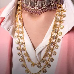 The art of layering. This image shows how a delicate polki choker can be paired with a longer, multi-strand necklace for a look that is both modern and traditional.