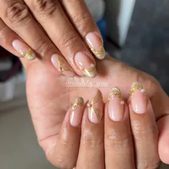An elegant pearl chrome design with delicate gold lines and tiny pearl accents. This is a perfect inspo for your next nail service.