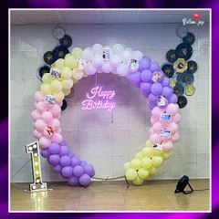 For a baby's first birthday, we created this vibrant, circular balloon arch with a custom "Happy Birthday" neon sign. To make it extra personal, we attached cherished family photos, creating a beautiful memory lane for the parents and guests.