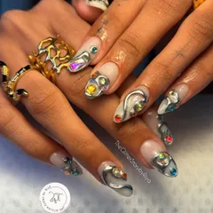 For those who love a bold, modern look, this one's for you. This set features abstract 3D silver chrome work, accented with multi-colored iridescent jewels for a futuristic and edgy vibe.