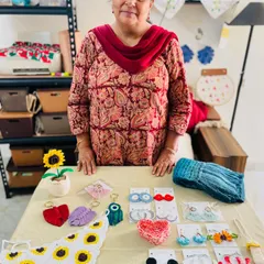 Here I am with a table full of small, handmade accessories ready to be shipped. This order for a former student included a crochet sunflower bandana, macrame keychains, earrings, and a woolen muffler.